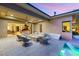 Outdoor patio with comfortable seating, a fire pit, and view of the interior through sliding glass doors at 38 Moonfire Dr, Las Vegas, NV 89135