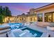 Outdoor oasis with a sparkling pool, spa, and covered outdoor kitchen and entertaining area at 38 Moonfire Dr, Las Vegas, NV 89135