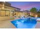Beautiful outdoor pool with stools and spa, perfect for relaxation and entertaining at 38 Moonfire Dr, Las Vegas, NV 89135