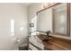 Chic powder room with a modern vessel sink, elegant mirror, and contemporary finishes at 38 Moonfire Dr, Las Vegas, NV 89135
