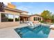 Backyard pool with built-in barstool seating, surrounded by lounge chairs and beautiful landscaping at 38 Moonfire Dr, Las Vegas, NV 89135