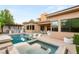 Backyard pool and outdoor kitchen featuring a built in grill and countertop seating beneath a trellis at 38 Moonfire Dr, Las Vegas, NV 89135