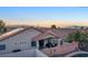 Sunset view of a desert community showcasing terra cotta roofs and palm trees at 387 Hoskins Ct, Henderson, NV 89012