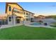 Expansive backyard features a refreshing swimming pool, artificial grass lawn, and elegant architecture at 387 Hoskins Ct, Henderson, NV 89012