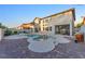 A luxurious backyard features a pool, spa, water features, and a covered patio for outdoor entertaining at 387 Hoskins Ct, Henderson, NV 89012