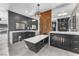 Modern bathroom with a freestanding tub, double vanities, and unique metallic backsplash feature and dark cabinets at 387 Hoskins Ct, Henderson, NV 89012