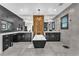 Bright bathroom featuring dual vanities, a standalone tub, and decorative wall feature enhancing its appeal at 387 Hoskins Ct, Henderson, NV 89012