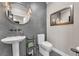 Stylish powder room featuring modern fixtures, a decorative mirror, and unique wall texture at 387 Hoskins Ct, Henderson, NV 89012