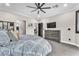 Bedroom with gray carpet, a mounted TV, and closet access, creating a relaxing retreat at 387 Hoskins Ct, Henderson, NV 89012