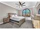 Bedroom with a ceiling fan, neutral walls, carpet, arched window, and dresser at 387 Hoskins Ct, Henderson, NV 89012