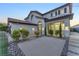 Elegant two-story home with a tile roof and desert landscaping at 387 Hoskins Ct, Henderson, NV 89012