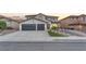 Beautiful two-story home with a two-car garage and xeriscaped front yard at 387 Hoskins Ct, Henderson, NV 89012