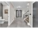 Inviting foyer with modern staircase, decorative lighting, and tile flooring at 387 Hoskins Ct, Henderson, NV 89012