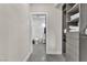 Hallway view into bathroom, showcasing patterned flooring and convenient closet storage at 387 Hoskins Ct, Henderson, NV 89012