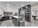 Modern kitchen featuring an island, stainless steel appliances, custom cabinets, and pendant lighting at 387 Hoskins Ct, Henderson, NV 89012
