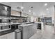 Open-concept kitchen with a central island, stainless steel appliances, and barstool seating at 387 Hoskins Ct, Henderson, NV 89012