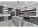 Spacious kitchen featuring dark custom cabinetry, floating shelves, and stainless-steel appliances at 387 Hoskins Ct, Henderson, NV 89012