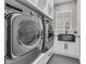 Laundry room with front load washer and dryer and black utility sink at 387 Hoskins Ct, Henderson, NV 89012