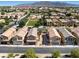 Scenic aerial shot showcasing a community with cozy homes, green spaces, and mountain views in the distance at 4351 Hera Temple Ave, North Las Vegas, NV 89031