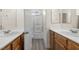 Bathroom featuring double sinks with wood vanities, and glass-enclosed shower at 4351 Hera Temple Ave, North Las Vegas, NV 89031