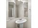 Bathroom with pedestal sink, tri-fold mirror, and simple design at 4351 Hera Temple Ave, North Las Vegas, NV 89031
