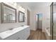 Bright bathroom featuring a double sink vanity, soaking tub and walk-in shower at 4351 Hera Temple Ave, North Las Vegas, NV 89031