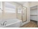 Bright bathroom featuring a soaking tub, walk-in shower and walk-in closet at 4351 Hera Temple Ave, North Las Vegas, NV 89031