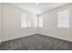 Cozy bedroom with three windows and plush carpeting throughout at 4351 Hera Temple Ave, North Las Vegas, NV 89031