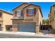 Charming two-story home featuring a neutral exterior, well-maintained landscaping, and a convenient attached garage at 4351 Hera Temple Ave, North Las Vegas, NV 89031