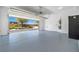 Spacious garage with epoxy flooring and an open door, providing ample parking and storage space at 4351 Hera Temple Ave, North Las Vegas, NV 89031