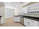 Stylish kitchen with white cabinets, granite countertops, and stainless steel dishwasher at 4351 Hera Temple Ave, North Las Vegas, NV 89031