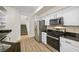 Modern kitchen featuring stainless steel appliances, granite countertops, and white cabinetry at 4351 Hera Temple Ave, North Las Vegas, NV 89031
