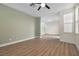 A bright and airy living room featuring wood-look floors, modern ceiling fan, and neutral paint at 4351 Hera Temple Ave, North Las Vegas, NV 89031