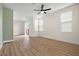 Bright, airy living room featuring wood floors, large windows, and a sliding glass door to a patio at 4351 Hera Temple Ave, North Las Vegas, NV 89031