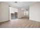 Bright living room with sliding glass door to the backyard, wood flooring, and ceiling fan at 4351 Hera Temple Ave, North Las Vegas, NV 89031