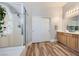 Bathroom with glass enclosed shower, double sink vanity, and wood look floors at 4361 Valley Quail Way, North Las Vegas, NV 89084