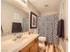Bathroom with wood-look floors, neutral walls, shower with tub, and a wood vanity at 4361 Valley Quail Way, North Las Vegas, NV 89084