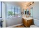 Functional bathroom features a window, wooden vanity, and a modern toilet at 4361 Valley Quail Way, North Las Vegas, NV 89084