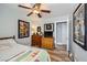 Bedroom with hardwood floors, ceiling fan, and eclectic poster art at 4361 Valley Quail Way, North Las Vegas, NV 89084