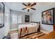 Bedroom featuring wood-look floors, a ceiling fan, and ample natural light from the window at 4361 Valley Quail Way, North Las Vegas, NV 89084
