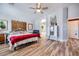 Bright bedroom boasts hardwood floors, vintage decor, and an arched doorway to the bathroom at 4361 Valley Quail Way, North Las Vegas, NV 89084