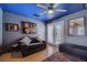 Inviting bonus room with a stylish gray sofa, unique artwork, and French doors for ample natural light at 4361 Valley Quail Way, North Las Vegas, NV 89084