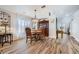 Charming dining area with wood floors, a classic dining set, and sheer curtains for soft, natural light at 4361 Valley Quail Way, North Las Vegas, NV 89084