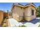 Close-up of the side of the home highlighting the stucco exterior, tiled roof, and desert landscaping at 4361 Valley Quail Way, North Las Vegas, NV 89084