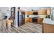 Bright kitchen features stainless steel appliances, wood cabinets, and wood-look floors, perfect for cooking and entertaining at 4361 Valley Quail Way, North Las Vegas, NV 89084