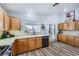 Well-equipped kitchen with wood cabinetry, stainless steel appliances, and bright countertops, perfect for Gathering meals at 4361 Valley Quail Way, North Las Vegas, NV 89084
