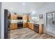 Well-lit kitchen featuring wood cabinets, modern appliances, and wood-look flooring for a warm, inviting space at 4361 Valley Quail Way, North Las Vegas, NV 89084