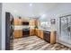 Modern kitchen with stainless steel appliances, wood cabinets, and white backsplash at 4361 Valley Quail Way, North Las Vegas, NV 89084