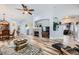 Bright and open living area featuring hardwood floors, a stone fireplace, and views into other rooms at 4361 Valley Quail Way, North Las Vegas, NV 89084