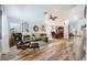 Spacious living room featuring wood floors, comfortable seating, and abundant natural light creating an inviting space at 4361 Valley Quail Way, North Las Vegas, NV 89084